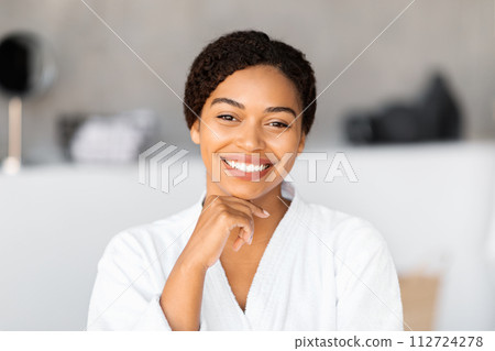 Radiant young black woman with beautiful skin smiling at camera 112724278