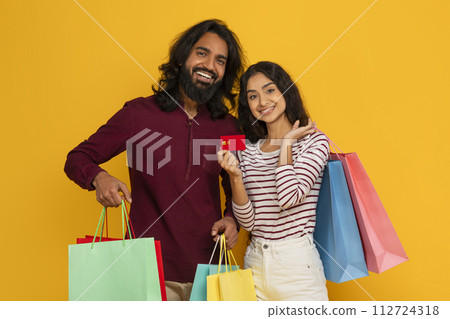 Happy eastern man and woman friends shopping together 112724318