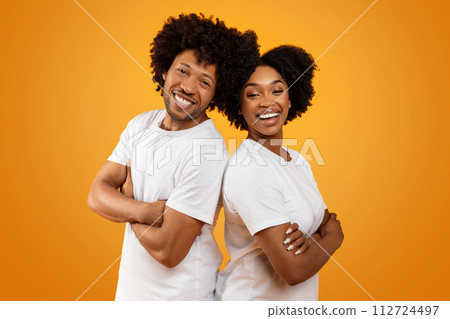 Positive black man and woman standing back to back Positive black man and woman standing back to back 112724497