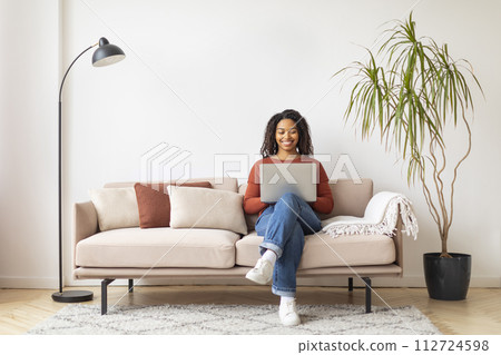 Modern Career. Smiling Black Woman Working With Laptop At Home Modern Career. Smiling Black Woman Working With Laptop At Home 112724598