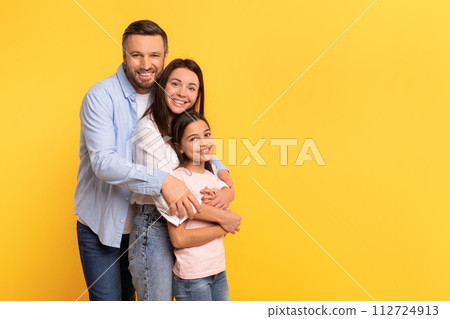 Happy Caucasian Man Hugging His Wife And Kid Daughter, Studio 112724913