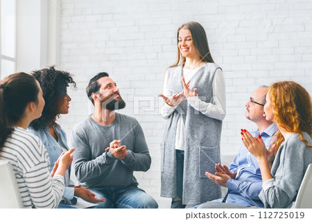 Happy Woman Sharing Her Recovery Story With Group On Therapy Session 112725019