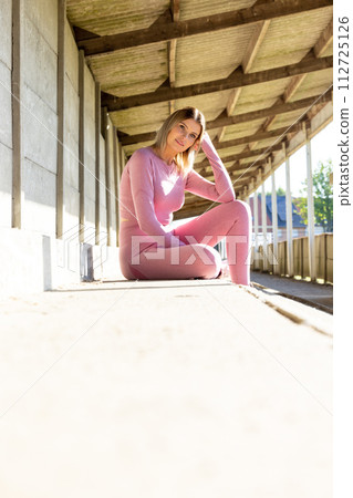Fitness Break: Woman in Pink Activewear Relaxing 112725126