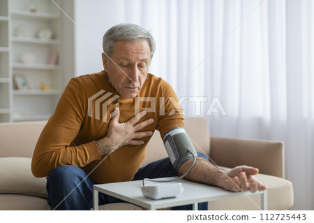 Shocked Elderly Man Measuring Arterial Blood Pressure Shocked Elderly Man Measuring Arterial Blood Pressure 112725443