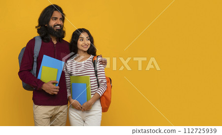 Curious indian man and woman students looking at copy space 112725939