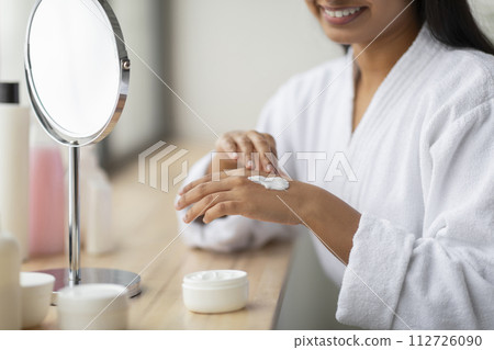 Cropped of indian woman enjoying her morning body care routine Cropped of indian woman enjoying her morning body care routine 112726090