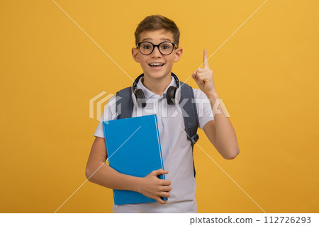 Excited Teen Boy Wearing Eyeglasses Having Idea, Raising Finger Up Excited Teen Boy Wearing Eyeglasses Having Idea, Raising Finger Up 112726293