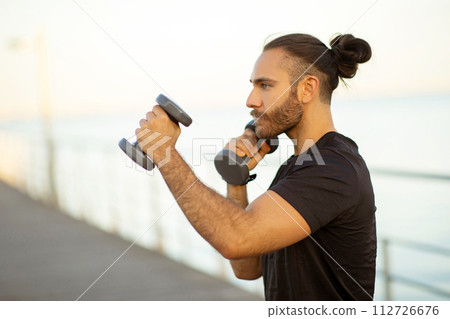 sporty guy in sportswear boxing outdoors by the seaside sporty guy in sportswear boxing outdoors by the seaside 112726676