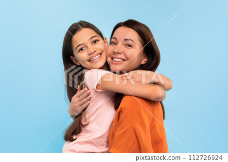 Portrait Of Smiling Young Mother And Cute Preteen Daughter Embracing 112726924