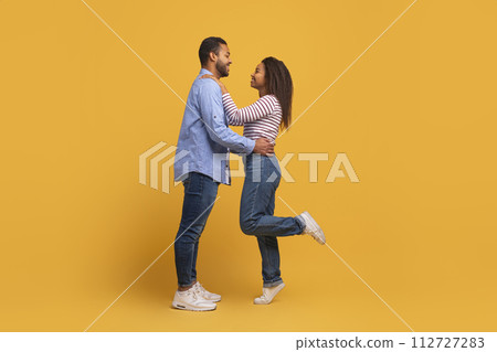 Couple In Love. Portrait of romantic black man hugging his girlfriend Couple In Love. Portrait of romantic black man hugging his girlfriend 112727283