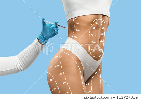 Young fit woman getting injection in her waist area 112727319