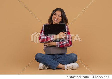 Emotional middle eastern woman hugging laptop with black screen 112727534