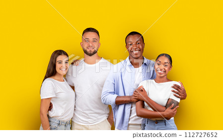 Two happy multicultural couples in casual attire, embracing and sharing a joyful moment Two happy multicultural couples in casual attire, embracing and sharing a joyful moment 112727652