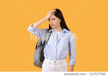 Stressed lady student with hand on forehead in moment of forgetfulness or headache 112727760