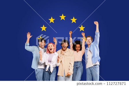Exuberant group of five young people with arms raised in victory and joy 112727871