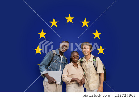 Three smiling students with backpacks and a laptop standing together Three smiling students with backpacks and a laptop standing together 112727965