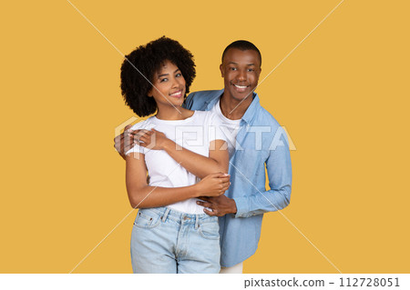 A young, attractive African American couple stands closely A young, attractive African American couple stands closely 112728051