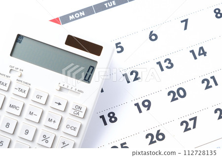 Calculator placed on the calendar Calculator placed on the calendar 112728135