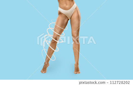 Attractive slim athletic woman legs on blue studio background 112728202