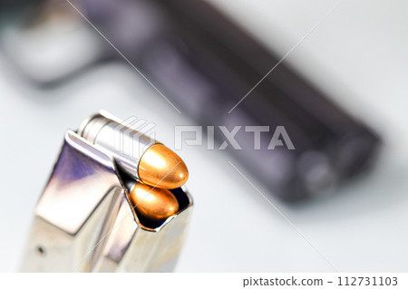 bullet 9mm FMJ (Full Metal Jacketed ) Shell Shock Technologies (NAS3) in magazines and 9mm postal gun in background. bullet 9mm FMJ (Full Metal Jacketed ) Shell Shock Technologies (NAS3) in magazines and 9mm postal gun in background. 112731103