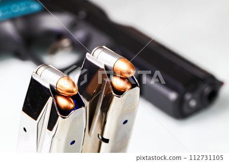 bullet 9mm FMJ (Full Metal Jacketed ) Shell Shock Technologies (NAS3) in magazines and 9mm postal gun in background. 112731105