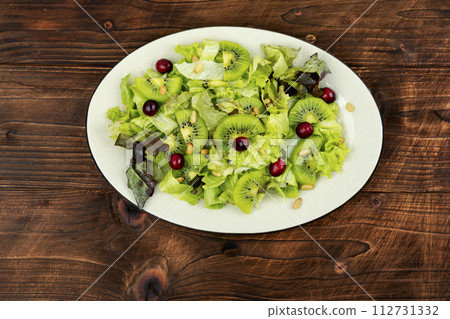 Healthy diet, salad of kiwi and herbs. 112731332