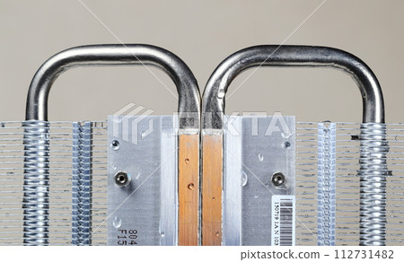 Close up view of passive heatsink with the aluminum fin and copper heat pipe structure isolate on white background. 112731482