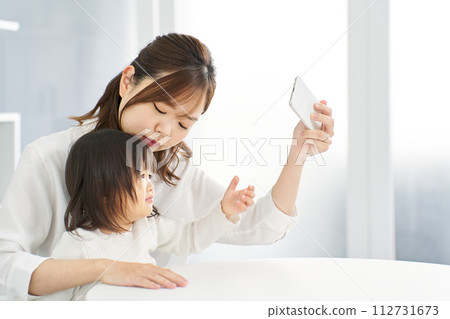 Mom takes smartphone away from child 112731673