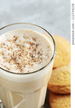 coffee with milk and grated nut in a glass close-up. Raff coffee 112734238