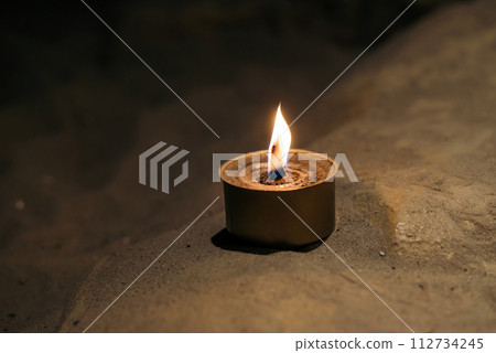 trench military candle isolated on white background. made by Ukrainian volunteers for soldiers serving on the front line. trench military candle isolated on white background. made by Ukrainian volunteers for soldiers serving on the front line. 112734245
