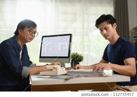 Millennial man discussing renovation project with professional interior designer 112735457