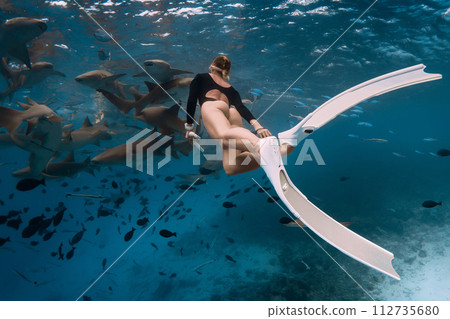 Woman snorkeling in tropical sea with nurse sharks in Bahamas Woman snorkeling in tropical sea with nurse sharks in Bahamas 112735680