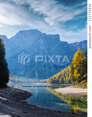Autumn peaceful alpine lake Braies or Pragser Wildsee. Dolomites Alps, Italy, Europe. People unrecognizuble. 112735834