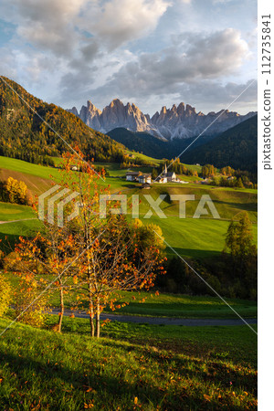 Autumn evening Santa Magdalena famous Italy Dolomites village view in front of the Geisler or Odle Dolomites mountain rocks. Autumn evening Santa Magdalena famous Italy Dolomites village view in front of the Geisler or Odle Dolomites mountain rocks. 112735841