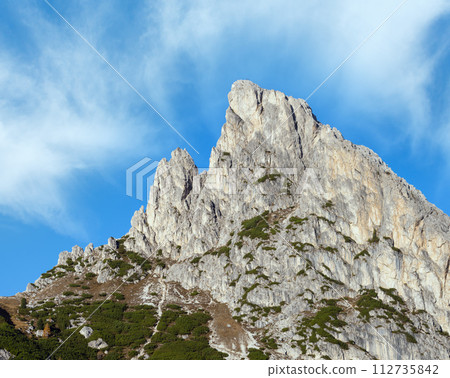Sunny colorful autumn alpine Dolomites mountain scene, Falzarego Pass, Sudtirol, Italy. 112735842