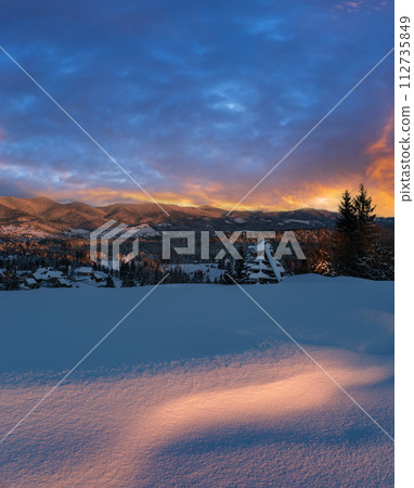 Alpine village outskirts in last evening sunset sun light. Winter snowy hills and fir trees. High resolution stitch image with great depth of field. Alpine village outskirts in last evening sunset sun light. Winter snowy hills and fir trees. High resolution stitch image with great depth of field. 112735849