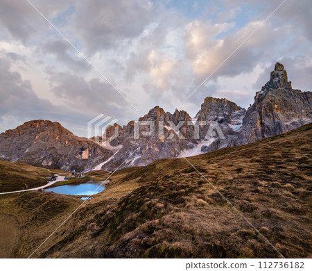 Evening twilight autumn alpine Dolomites mountain scene, Trento, Italy. Lake or Laghetto Baita Segantini view. 112736182