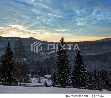 Small and quiet alpine village and winter sunrise snowy mountains around, Voronenko, Carpathian, Ukraine. Small and quiet alpine village and winter sunrise snowy mountains around, Voronenko, Carpathian, Ukraine. 112736202