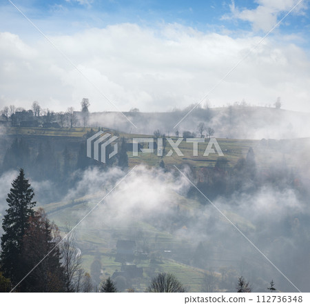 Morning foggy clouds in autumn mountain countryside.  Ukraine, Carpathian Mountains, Transcarpathia. 112736348