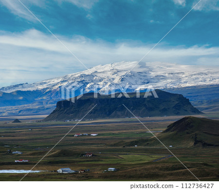Picturesque autumn evening view to highlands and plain not far from ocean shore from Dyrholaey Cape Viewpoint, Vik, South Iceland. Picturesque autumn evening view to highlands and plain not far from ocean shore from Dyrholaey Cape Viewpoint, Vik, South Iceland. 112736427