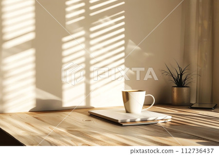 Cozy morning vibes with sunlight casting shadows through blinds 112736437