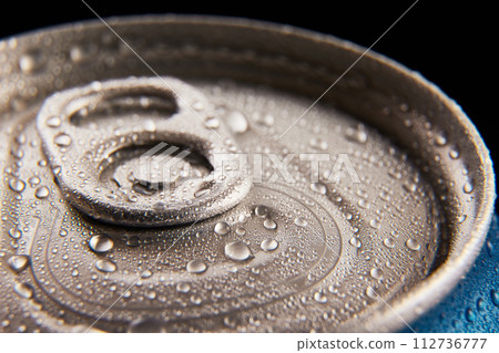 Close-up photo of aluminum closed jar of beer, coke, soda with condensation water drops against black background 112736777