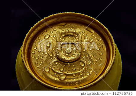 Close-up photo of golden aluminum closed can, jar of beer, coke, soda with condensation water drops against black background. Close-up photo of golden aluminum closed can, jar of beer, coke, soda with condensation water drops against black background. 112736785