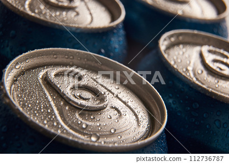 Close-up of several aluminum cans, jars of beer, coke, soda with condensation drops Close-up of several aluminum cans, jars of beer, coke, soda with condensation drops 112736787