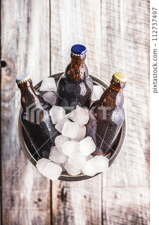 Bucket Filled With Ice and three Bottles of Beer 112737497