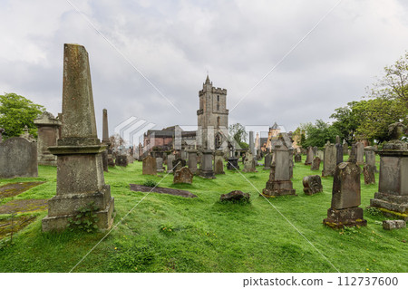 Stirling cemetery lush greenery surrounds ancient gravestones, Church of the Holy Rude towering Stirling cemetery lush greenery surrounds ancient gravestones, Church of the Holy Rude towering 112737600