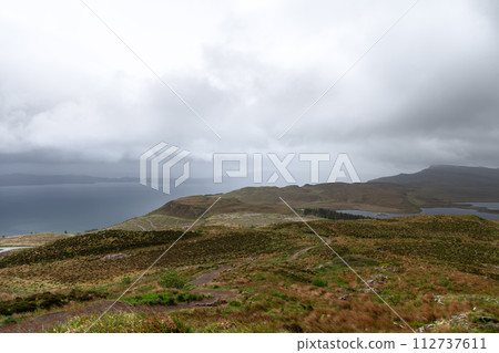 From Isle of Skye's iconic trail a moody landscape unfolds where land embraces misty Sound of Raasay From Isle of Skye's iconic trail a moody landscape unfolds where land embraces misty Sound of Raasay 112737611