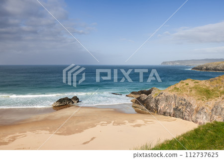 The unspoiled charm of Durness Beach with gentle azure waters against pristine sand 112737625