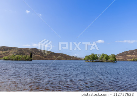 Nestled in a Scottish loch, an island bursts with greenery, home to elusive red deer Nestled in a Scottish loch, an island bursts with greenery, home to elusive red deer 112737628