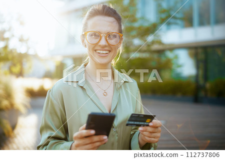smiling modern woman employee in green blouse and eyeglasses smiling modern woman employee in green blouse and eyeglasses 112737806